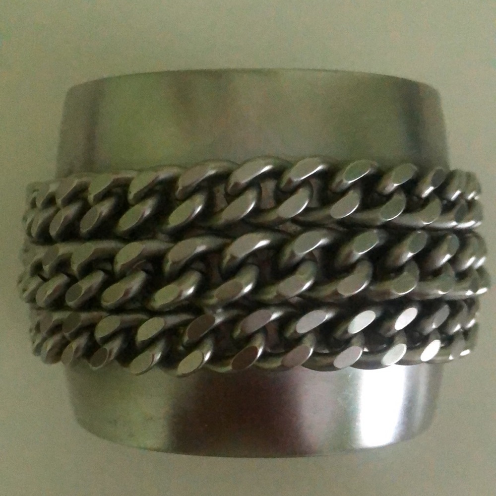 Cuff statement bracelet w/ 3 rows of attached chain detail.